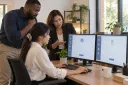 A manager and two colleagues identify a repetitive office task on their screens.